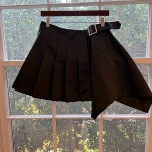 A. L. C. Satin mini asymmetrical pleated mini skirt with rhinestone belt.